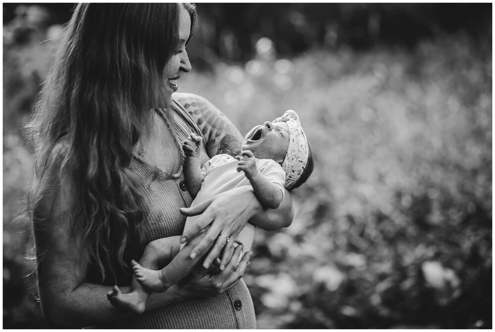 Oneonta NY Newborn Photographer, baby yawning in mom's arms outside
